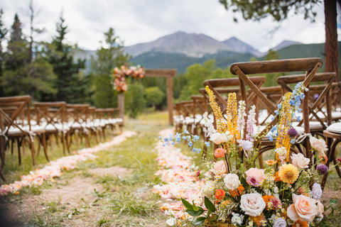 Wedding flower details featuring Colorado-inspired bridal bouquet with garden roses and local greenery against rustic outdoor backdrop